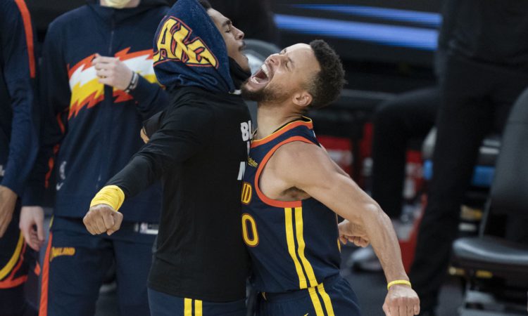 January 25, 2021; San Francisco, California, USA; Golden State Warriors guard Jordan Poole (left) celebrates with guard Stephen Curry (right) against the Minnesota Timberwolves during the fourth quarter at Chase Center. Mandatory Credit: Kyle Terada-USA TODAY Sports