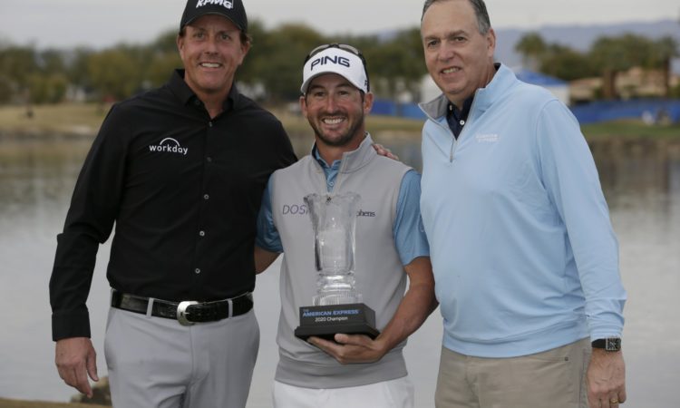 Andrew Landry, center, holds the trophy with Phil Mickelson, left, and CEO of American Express Steve Squeri after winning The American Express golf tournament on the Stadium Course at PGA West in La Quinta, Calif., Sunday, Jan. 19, 2020. (AP Photo/Alex Gallardo)