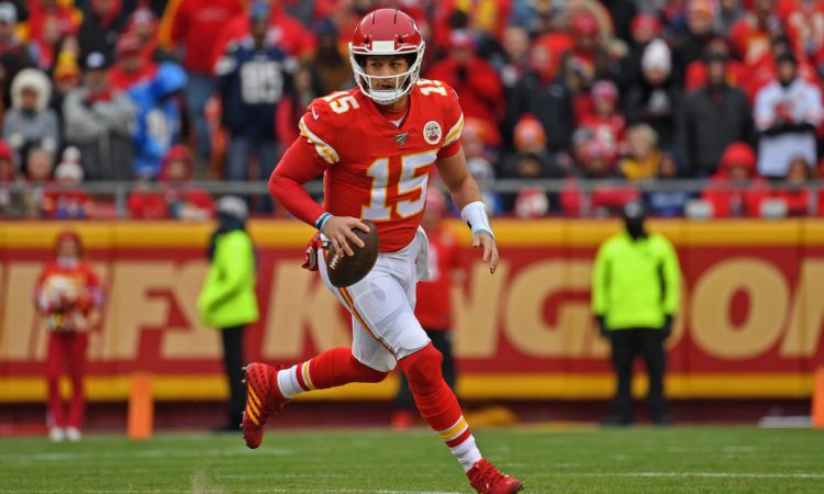 KANSAS CITY, MO - DECEMBER 29:  Quarterback Patrick Mahomes #15 of the Kansas City Chiefs rolls out against the Los Angeles Chargers during the first half at Arrowhead Stadium on December 29, 2019 in Kansas City, Missouri. (Photo by Peter G. Aiken/Getty Images)